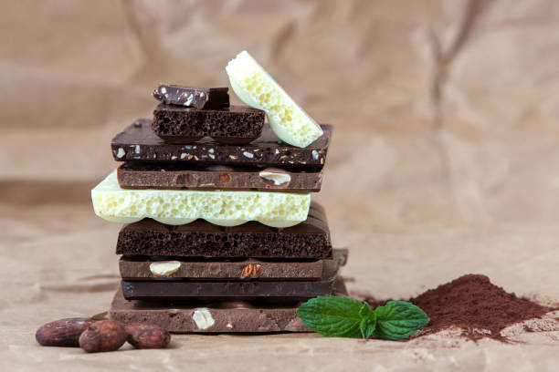 istock Different kinds of chocolates with nuts cocoa powder and mint - selective focus, wrapping brown paper background 1227287901