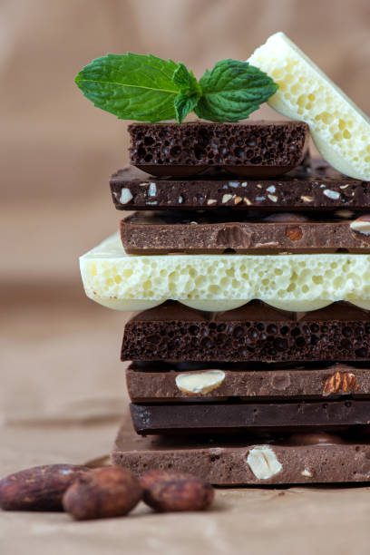 istock Different kinds of chocolates with nuts cocoa powder and mint - selective focus, wrapping brown paper background 1227288038