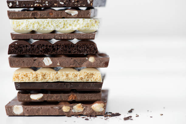 istock Different kinds of chocolates with nuts cocoa powder and mint - selective focus, white background 1227289208