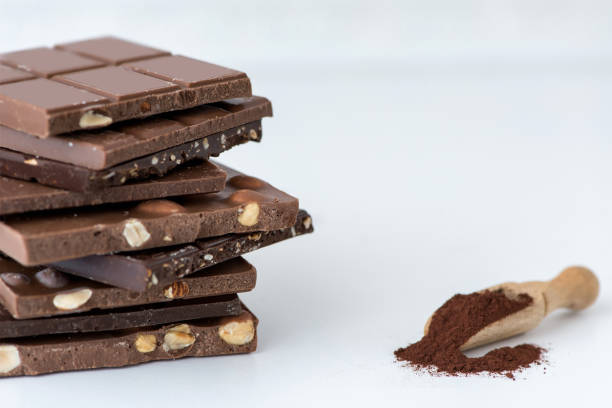 istock Different kinds of chocolates with nuts cocoa powder and mint - selective focus, white background 1227290413