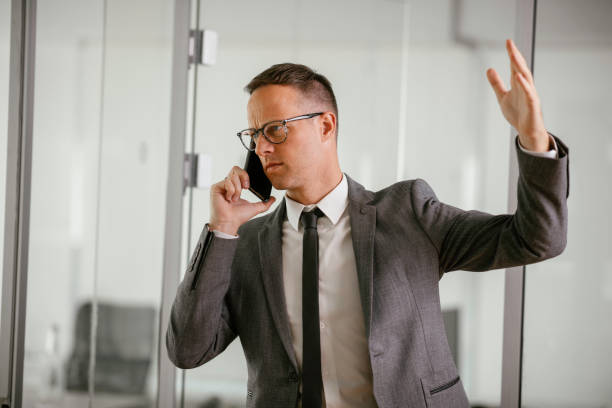 istock Businessman talking to the phone in office 1227290537