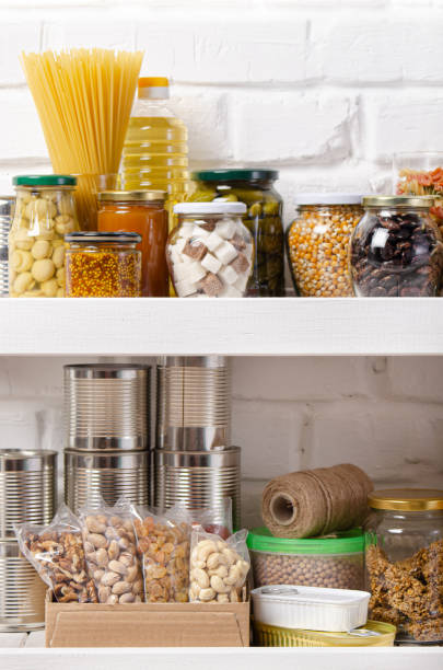 istock Set of non-perishable foods on pantry shelf on brick wall background 1227290772