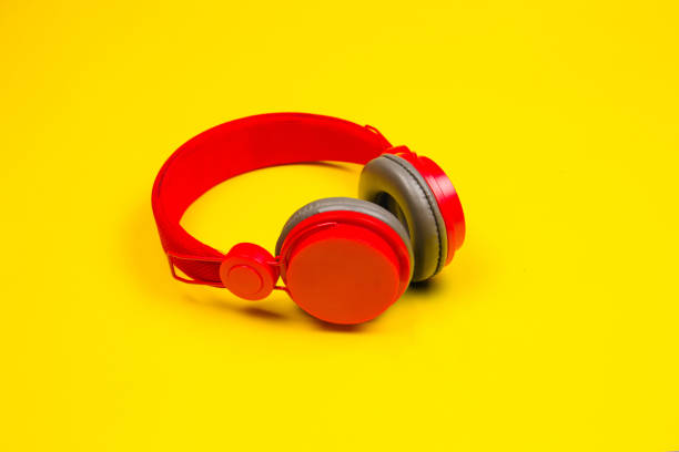 istock Red headphones on yellow background. Music concept 1227291608