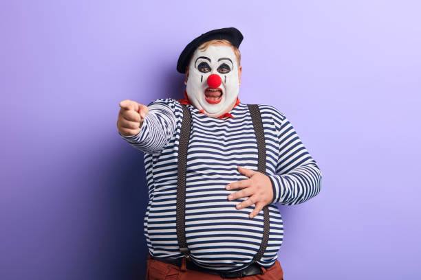 istock fat clown showing direction with index finger 1227292089