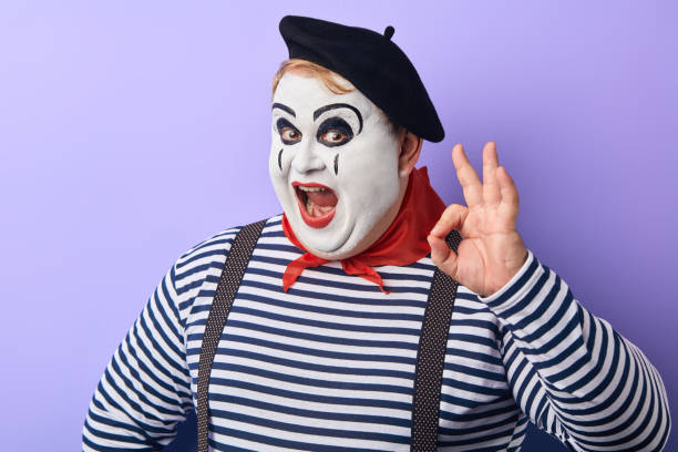 istock plump clown showing OK sign, making funny grimaces 1227292219