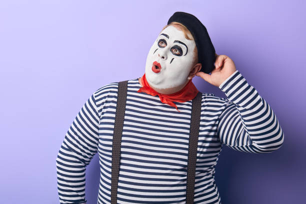 istock pensive mime touching his cap and looking up isolated on blue 1227292343