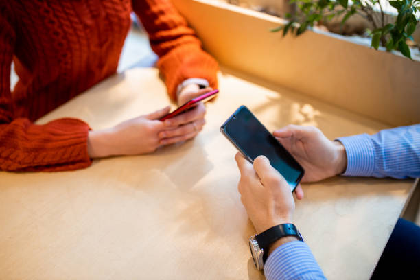 istock close-up of people using smartphone 1227293020