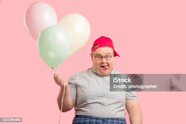 Funny Man Much Similar To Winnie The Pooh With Air Baloons Isolated Over Pink Stock Photo - Download Image Now
