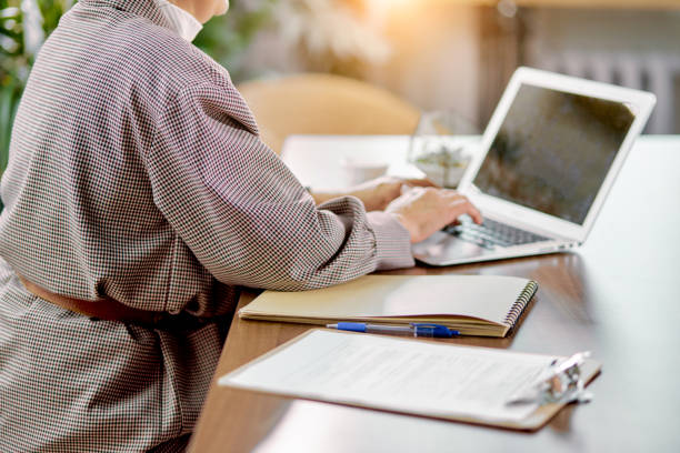 istock Cropped lady typing on laptop 1227295776
