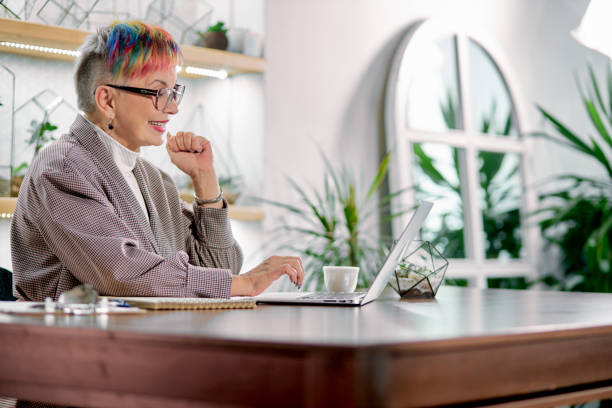 istock Mature business lady have rest sitting with laptop 1227296431