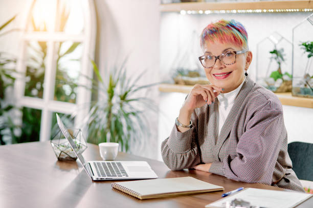istock Business female sitting with laptop in light room 1227296480