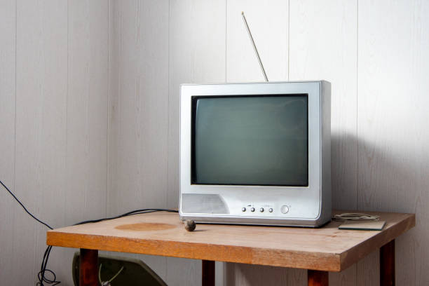 istock A retro TV with antennas stands on a dusty table. Angle view 1227305907