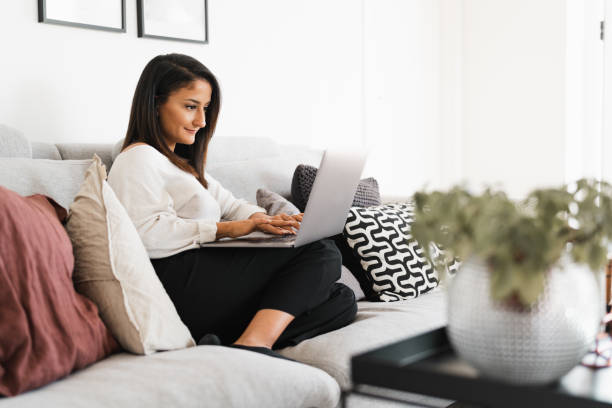 istock Woman is working from her couch at home 1227305970