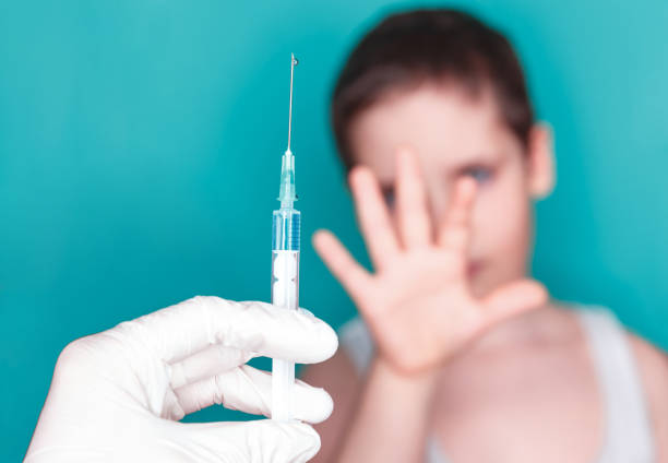 istock Young boy doesn't want to do medical injection. Vaccination concept 1227306032
