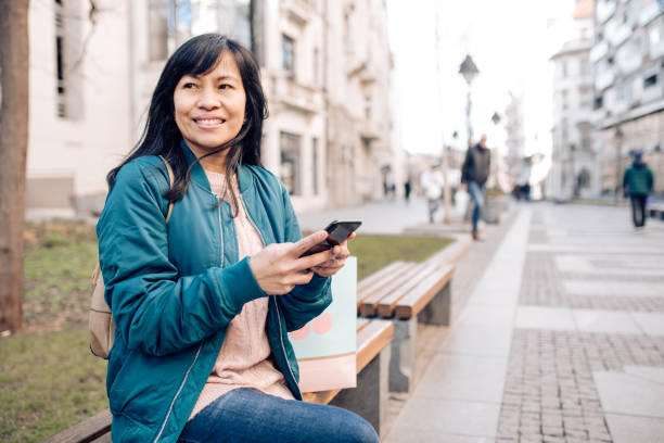 istock Asian woman using phone after shopping 1227307045
