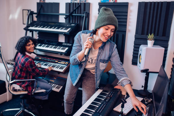 istock Singer and a keyboard player recording a song in the studio 1227307103