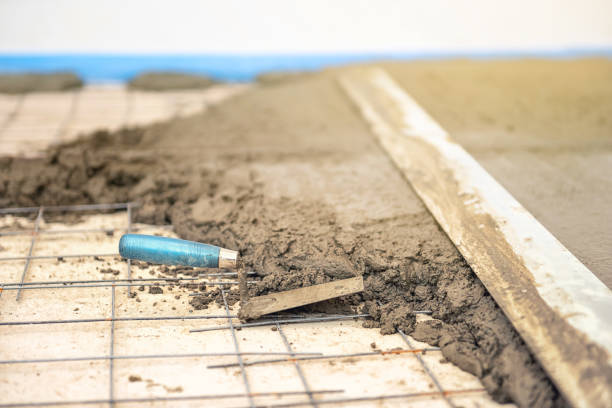 istock Builder worker plastering concrete at floor of house construction 1227309191