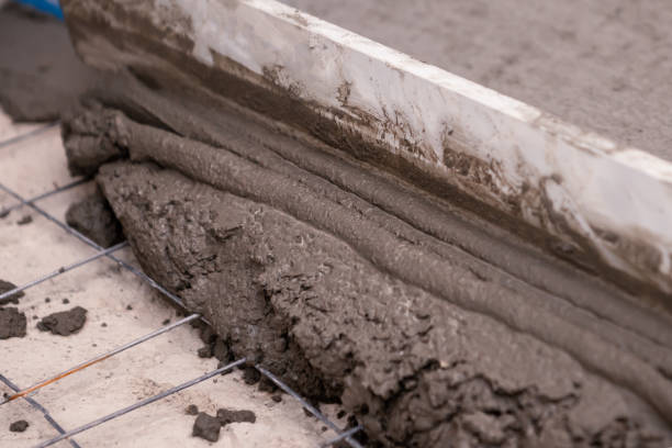 istock Builder worker plastering concrete at floor of house construction 1227309202