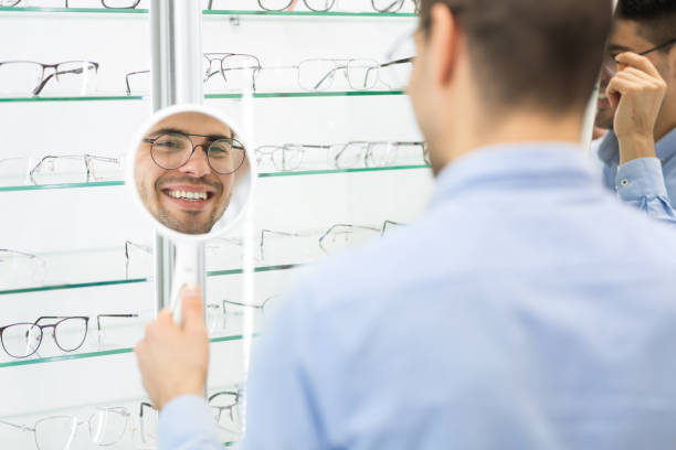 istock Happy man choosing glasses at optics store 1227309735