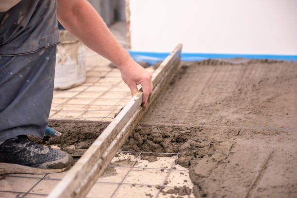 istock bricklayer aligns cement screed in a newly built house 1227309789