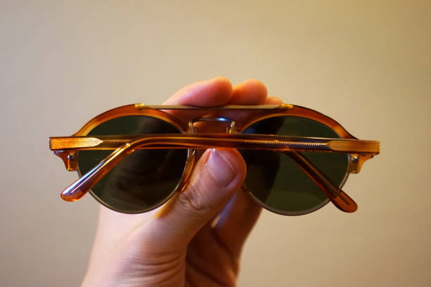 istock Close up Hand holding back side view of sunglasses 1227309975