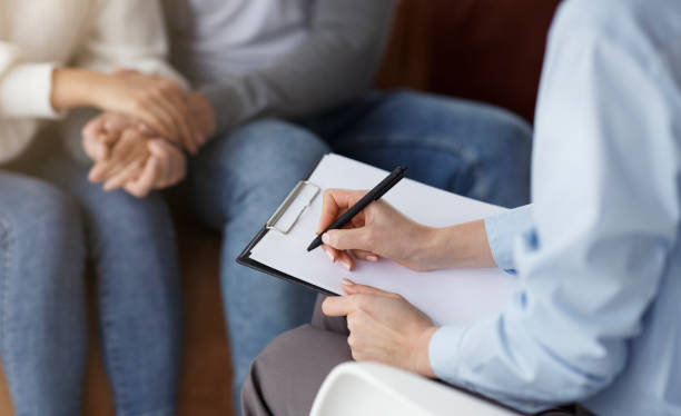 istock Marital Therapist Taking Notes Talking With Couple In Office, Cropped 1227310742