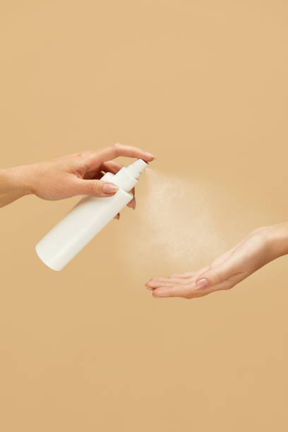 istock Antiseptic. Female Hands Using Spray Sanitizer On Beige Background. Daily Hygiene Routine With Antibacterial Products For Virus Prevention And Staying Healthy. 1227313599