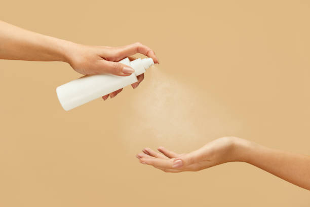 istock Sanitizer. Female Hands Using Spray Antiseptic On Beige Background. Daily Hygiene Routine With Antibacterial Products For Virus Prevention And Staying Healthy. 1227313622