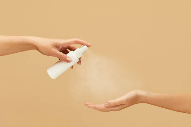 istock Hygiene. Female Hands Using Spray Antiseptic On Beige Background. Daily Routine With Antibacterial Products For Virus Prevention And Staying Healthy. 1227314014