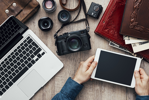 Hipster photography equipment with laptop and digital tablet on a vintage wooden desktop, flat lay