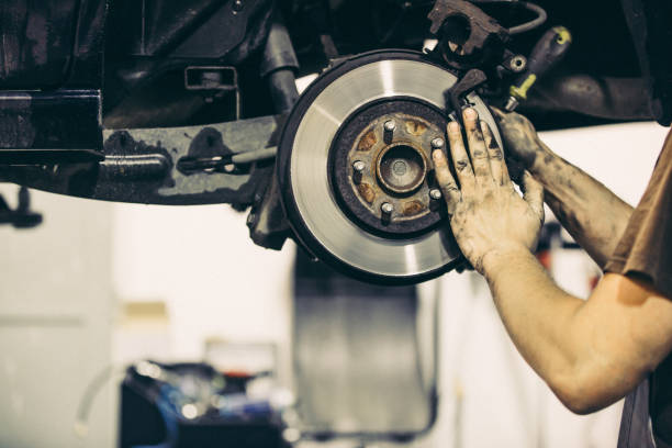 istock Car mechanic changing car brakes, transportation concept (color toned image) 1227316863