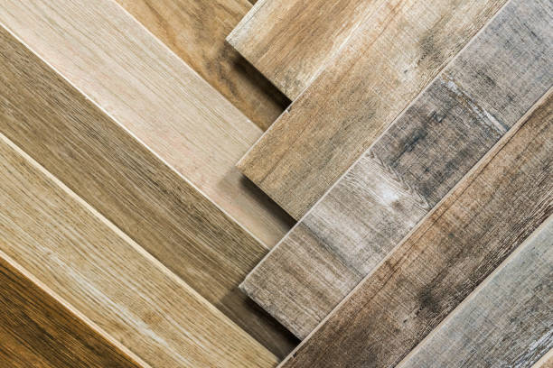 Variety of wooden like tiles. Samples of fake wood tiles for flooring. Assortment of floor laminate / tiles in an interior shop. stock photo