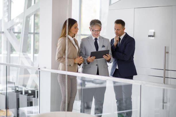 istock Group of mixed aged business people collaborating over digital tablet 1227318257