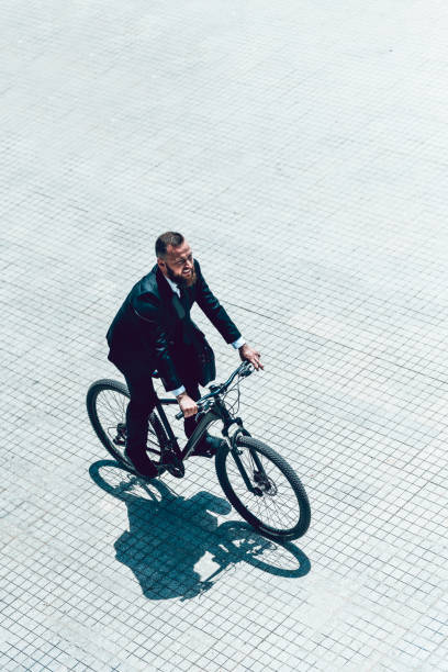 istock Businessman Riding Bicycle To Work On A Sunny Day 1227319025