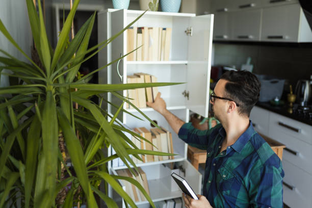 istock Millennial man organizing his book collections 1227319304