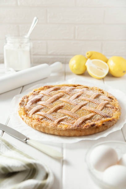 Homemade shortbread lemon pie with a wicker pattern sprinkled with powdered sugar. stock photo