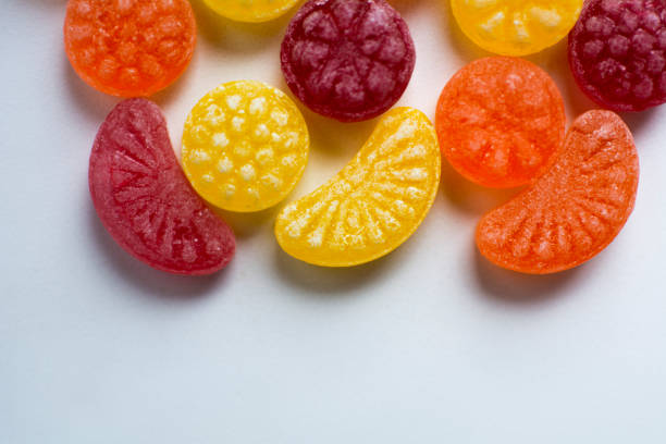 istock little fruit colored sweet lollipops isolated on white background 1227321632