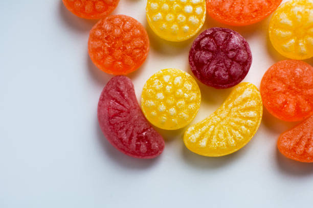 istock little fruit colored sweet lollipops isolated on white background 1227321643