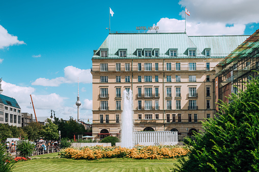 Berlin, Germany - August 17, 2016: Hotel Adlon, luxury hotel in Berlin opened in 1907. View to east, to TV Tower, Pariser Platz in Berlin, Germany.