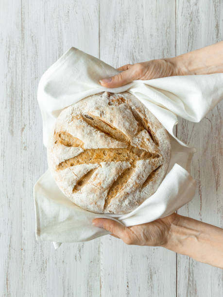 istock No knead baked bread in a hand. 1227325189