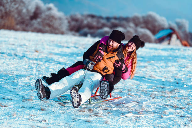 istock Siblings Enjoying Downhill Snow Tumble On A Sledge Together 1227325280