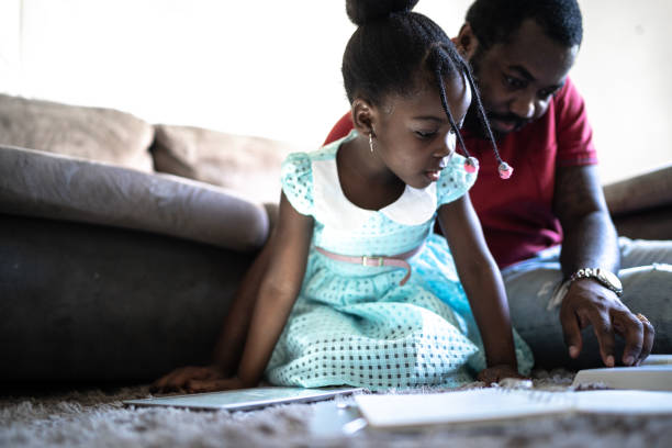 istock Dad helping his child doing homework at home 1227327130
