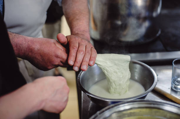 istock The home-made cheese maker produces handmade mozzarella with fresh quality milk. Concept: tradition, italy, mozzarella.The process of making mozzarella. Film noise. 1227328362