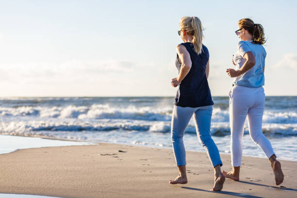 istock Two women running on beach 1227328525