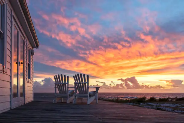 Two Ampty Chairs Facing Magnificent Sunset View at Beach