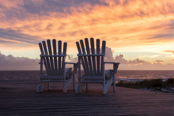 istock Two Ampty Chairs Facing Magnificent Sunset View at Beach 1227329119