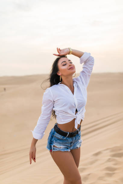 istock Young beautiful woman posing on desert landscape. 1227329780