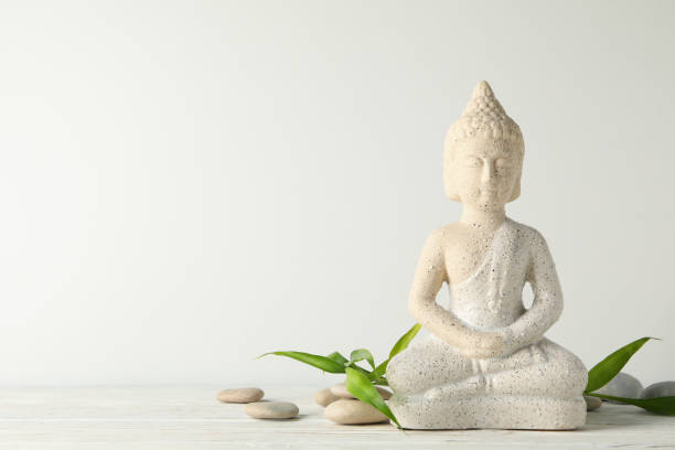 istock Buddha and stones on wooden table. Zen concept 1227329788
