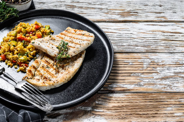 istock Grilled Turkey breast Steaks with quinoa salad. White background. Top view. Copy space 1227330226