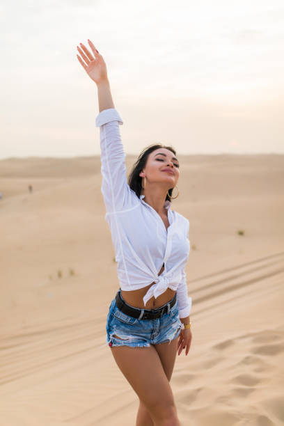 istock Young beautiful woman posing on desert landscape. 1227330359